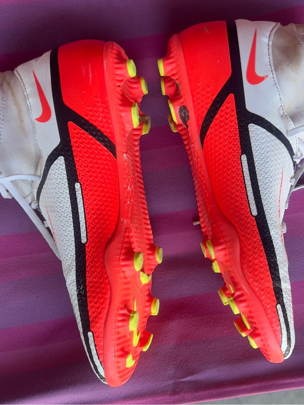 Nike White Soccer Cleats with Neon Red-Orange Outsole and Yellow Studs